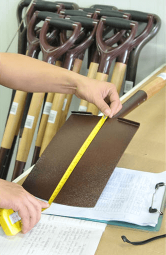 Size measurement process with a person measuring a product with a yellow measuring tape