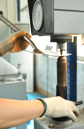 Hardness test being performed on a metal part using a hardness testing machine