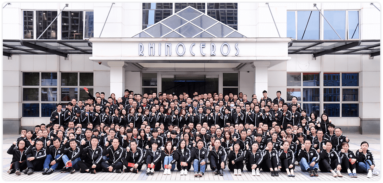 Large group of employees standing in front of the RHINOCEROS building